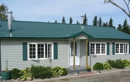 Residential building with a facade of light green siding