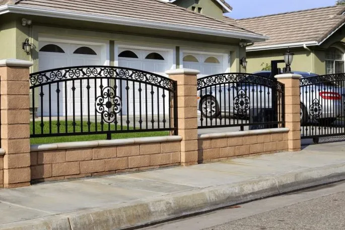 House wall fence with carved wrought iron